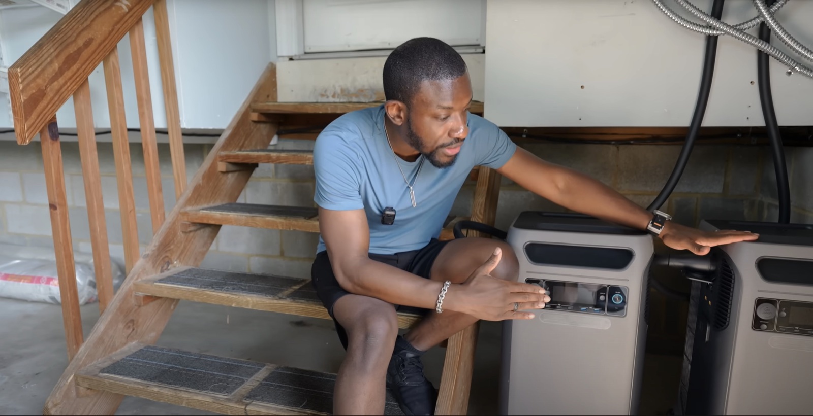 Man connecting backup power units in a house basement